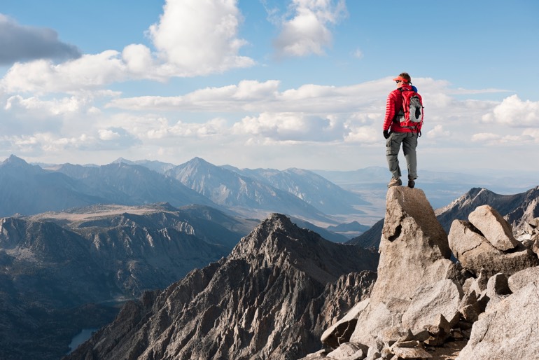 Man achieving goals and reaching new heights